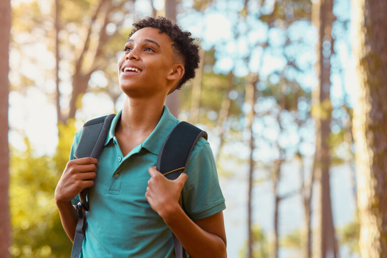 Male student with backpack outdoors